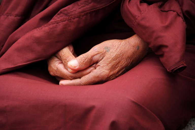 hands of Buddhist Nun in lap